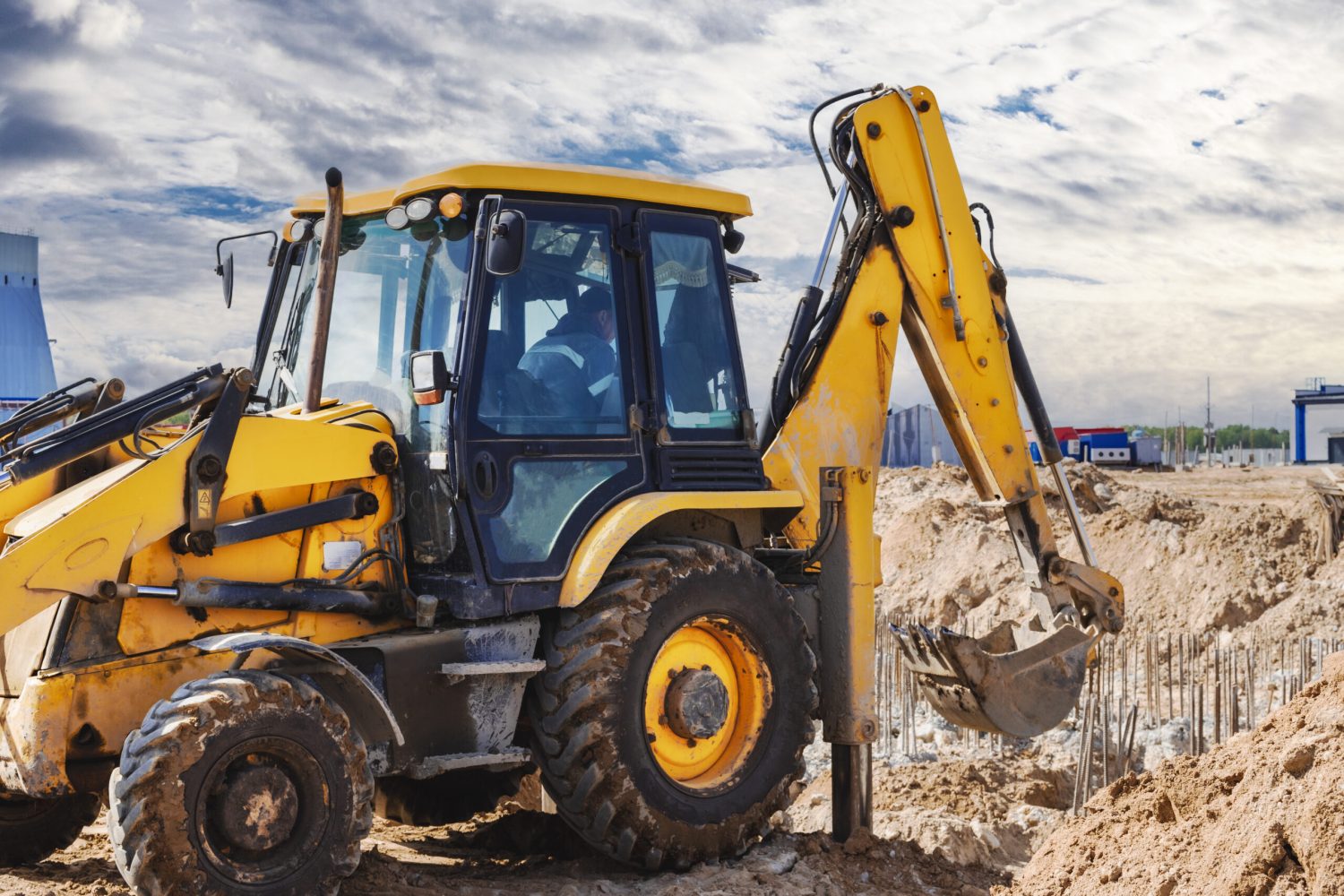 Excavator digs piles. Earthworks for the construction of the foundation. Construction equipment for the device of piles. Preparatory work for grillage